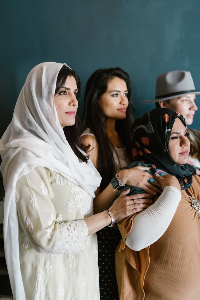 A diverse group of women posing in a studio, symbolizing empowerment and unity.